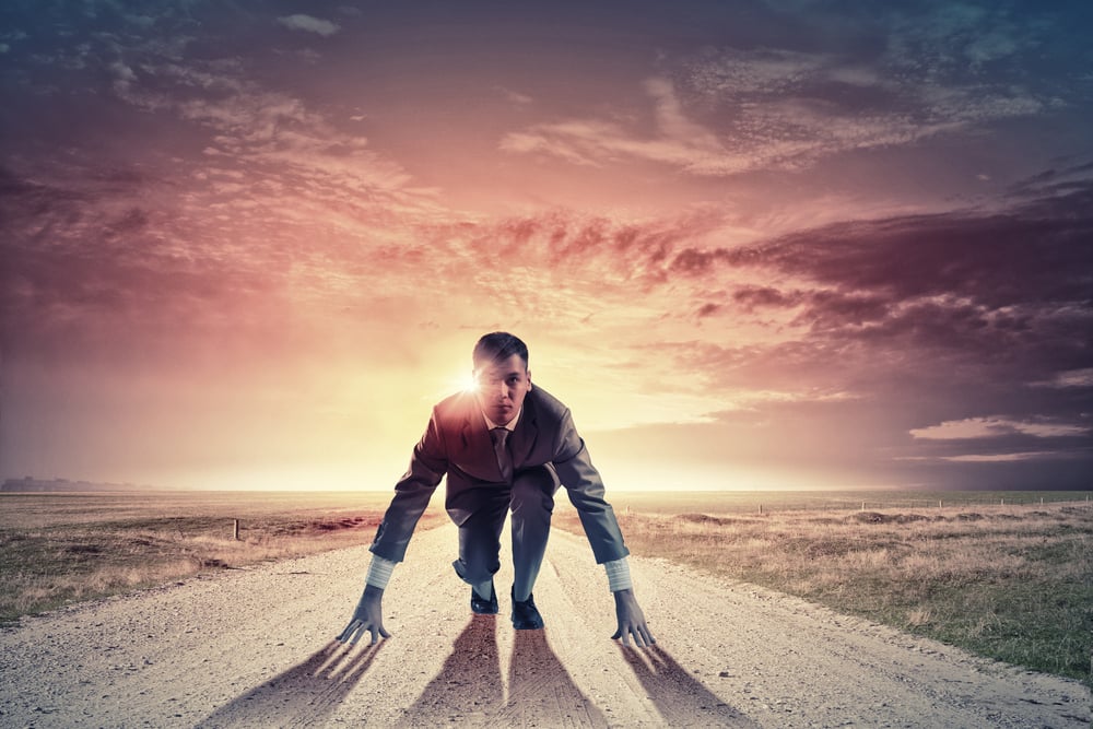 Young determined businessman standing in start position Young determined businessman standing in start position